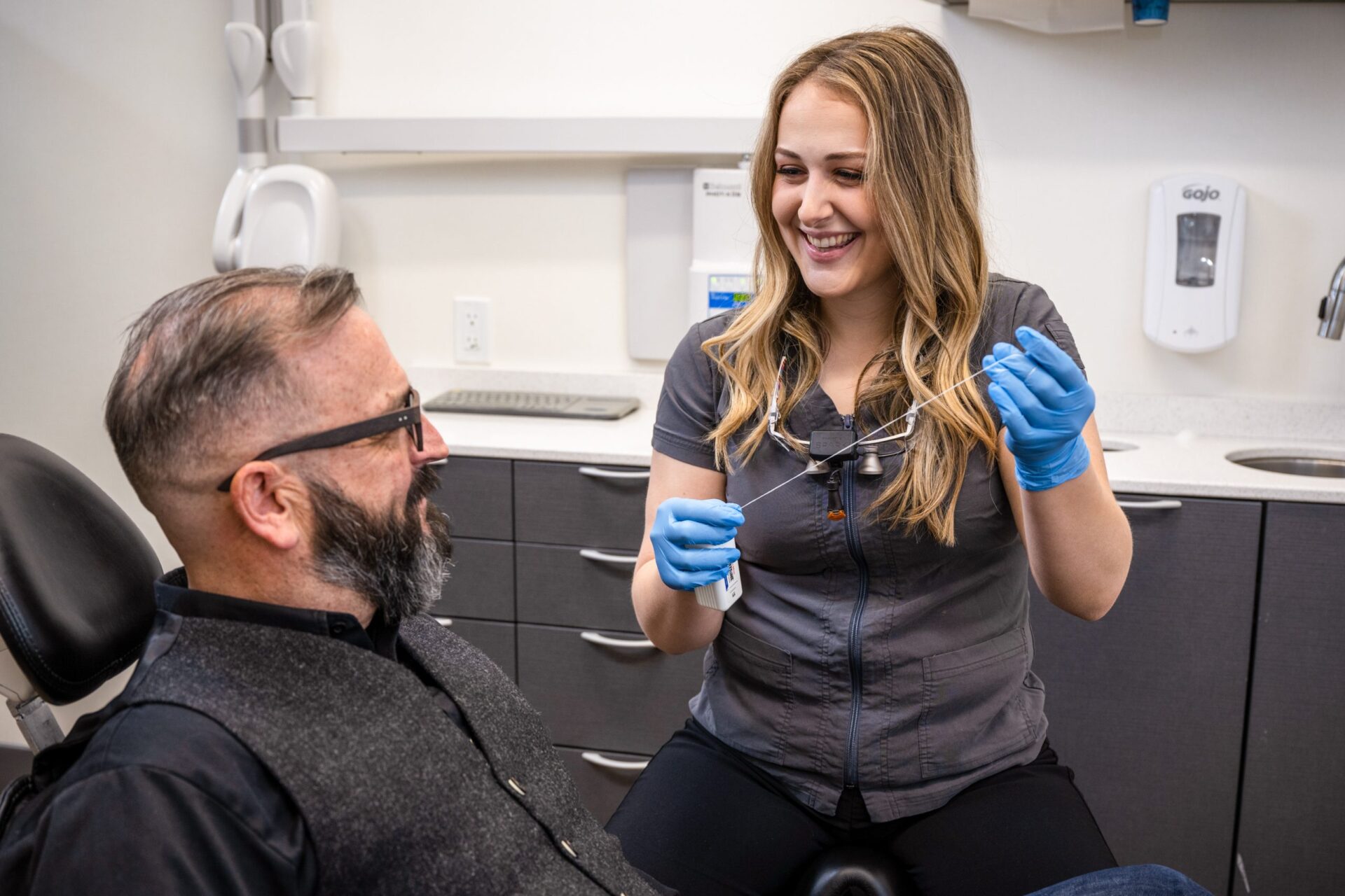 Showing patient how to floss